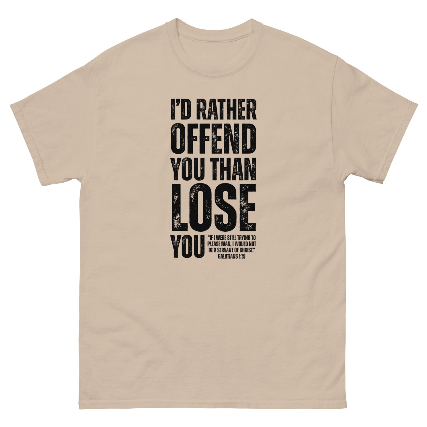 Front, Sand t-shirt with bold black text reading “I’D RATHER OFFEND YOU THAN LOSE YOU” and a smaller quote from Galatians 1:10 below the main message.
