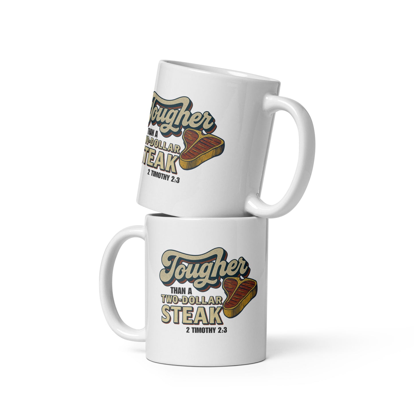 Two white ceramic mugs stacked together, each featuring a vintage-style design that reads 'Tougher Than a Two-Dollar Steak' with a cartoon steak graphic and '2 Timothy 2:3' underneath, displayed against a plain white background.