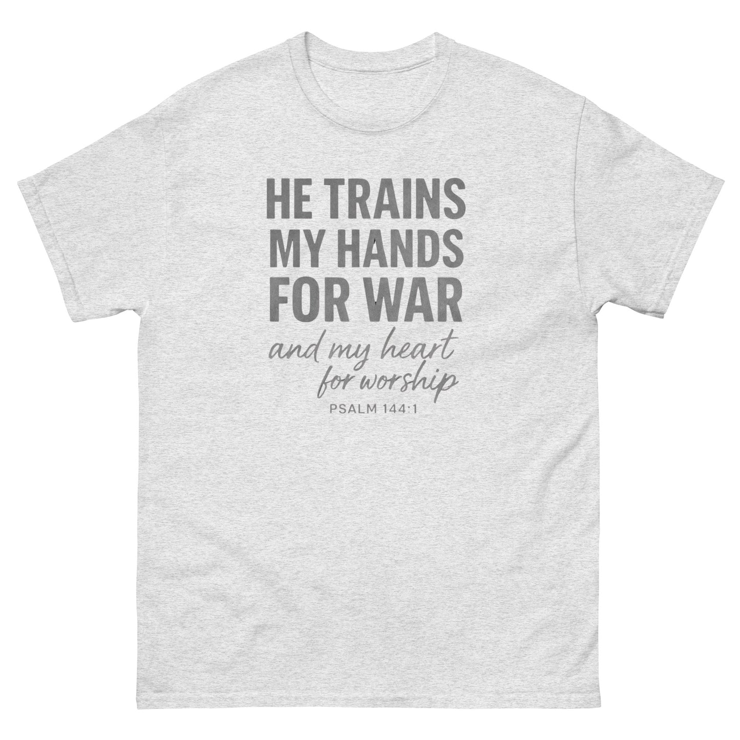 Front, Ash color t-shirt with bold white text reading “He trains my hands for war and my heart for worship – Psalm 144:1,” designed for faith-based wear.