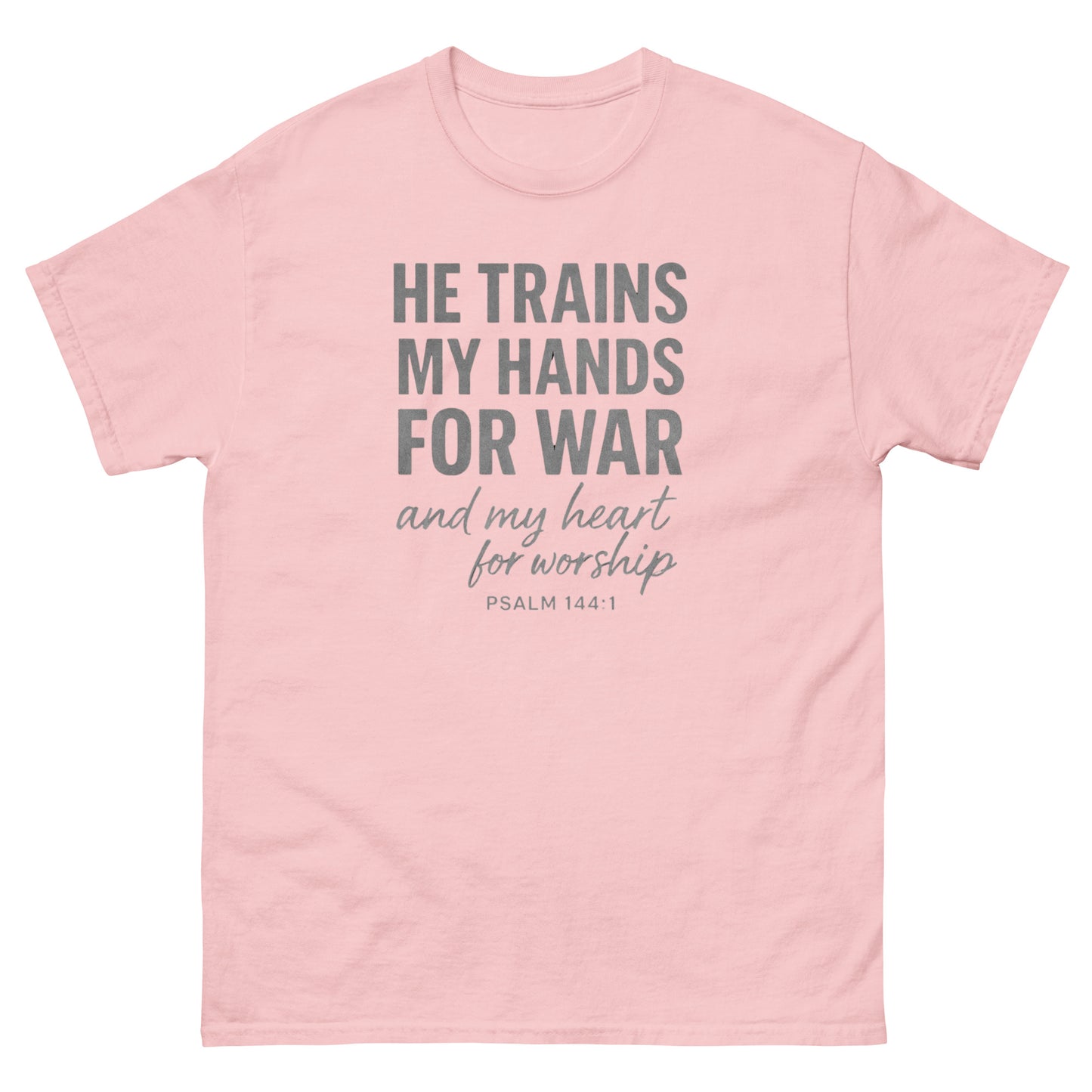Front, Light Pink t-shirt with bold white text reading “He trains my hands for war and my heart for worship – Psalm 144:1,” designed for faith-based wear.