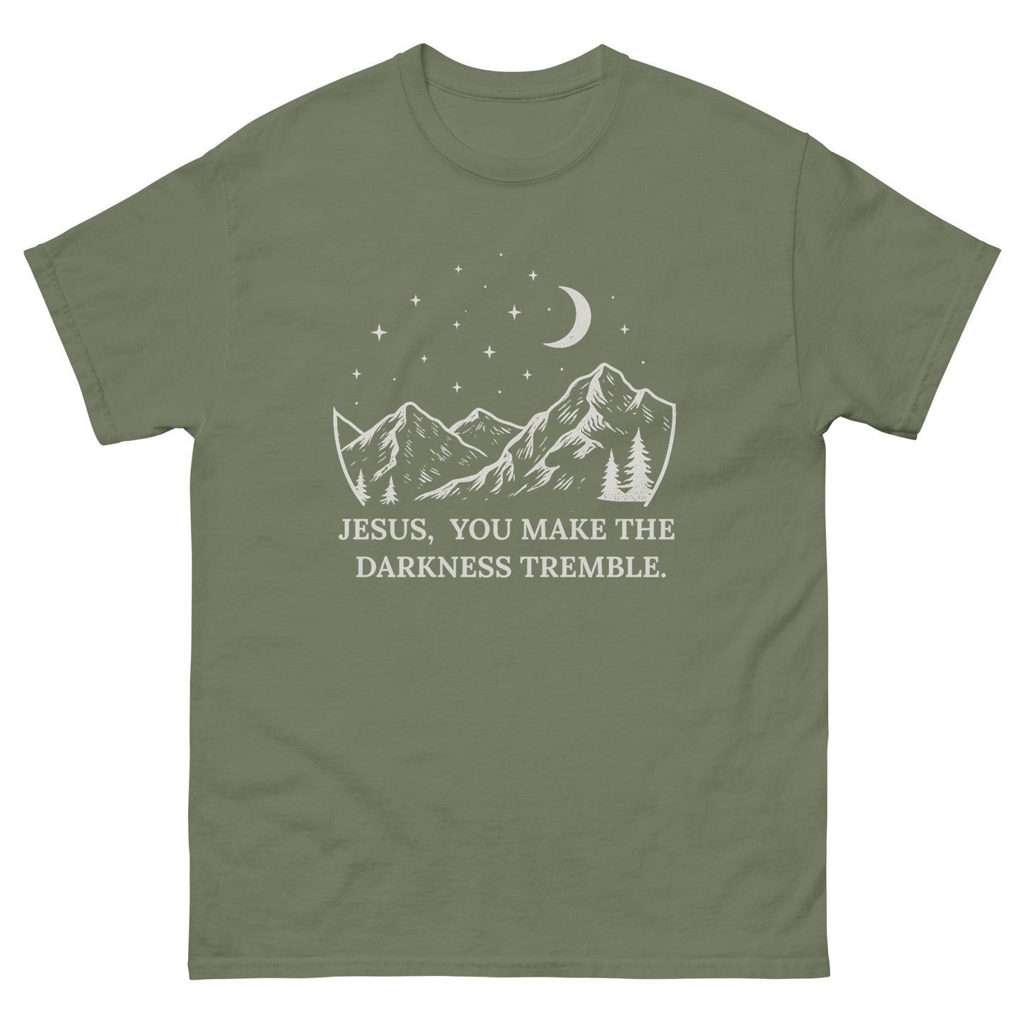 unisex T-shirt featuring a white line-art design of mountains, trees, crescent moon, and stars. Below the artwork, the text reads: "Jesus, You Make the Darkness Tremble." Front, Military Green