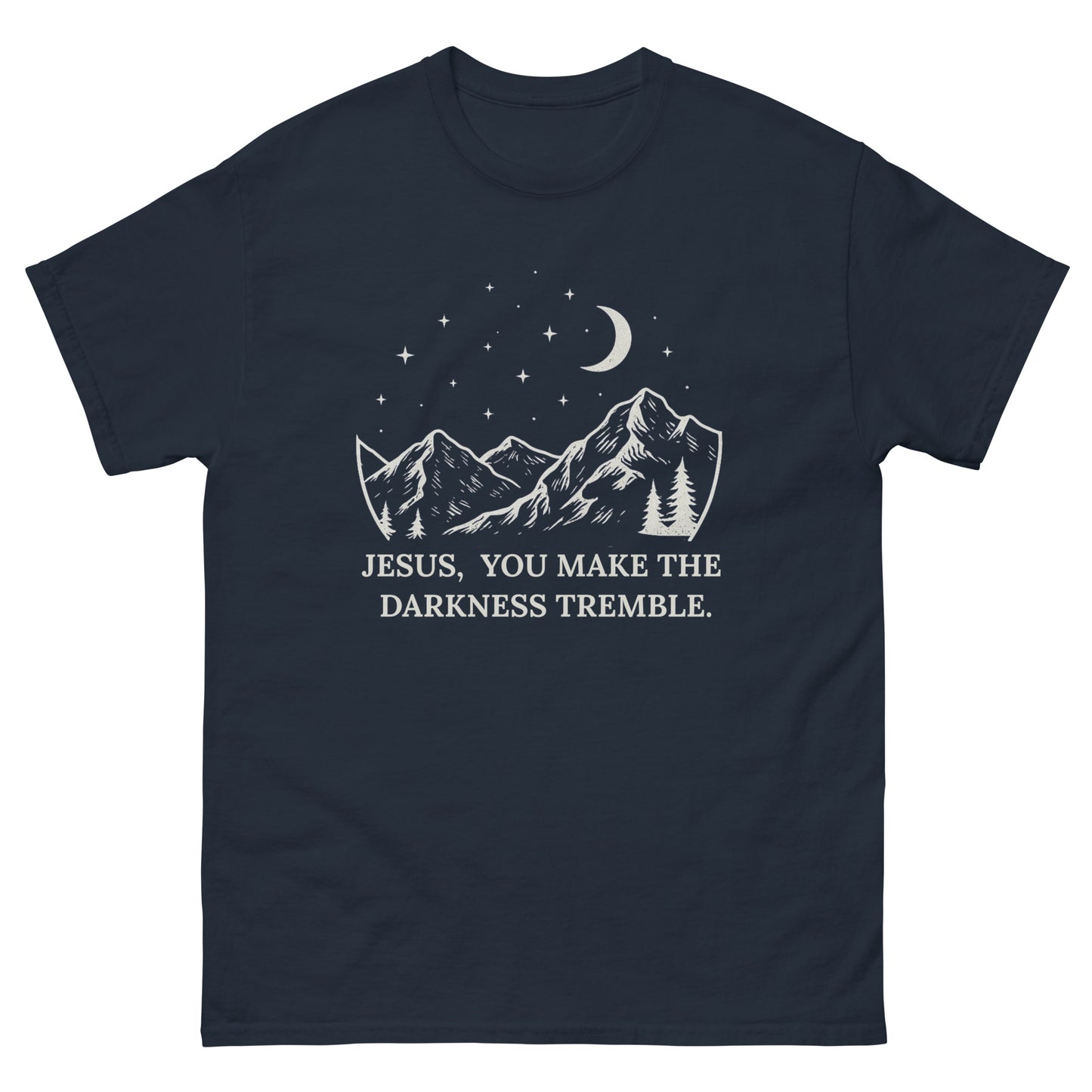 unisex T-shirt featuring a white line-art design of mountains, trees, crescent moon, and stars. Below the artwork, the text reads: "Jesus, You Make the Darkness Tremble." Front, navy