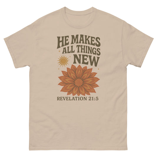 "He Makes All Things New" t-shirt featuring Revelation 21:5 with a vibrant floral design and sunburst, symbolizing new beginnings and God's renewing power, front, sand color